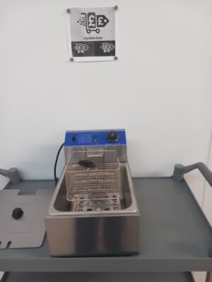 Front view of a commercial deep fryer with lid removed and frying basket hanging above, showcasing the high-capacity frying area, perfect for fast-paced commercial cooking.