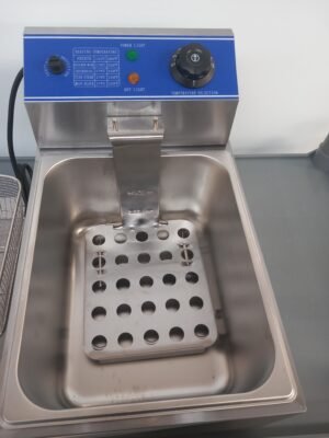 Top view of a commercial deep fryer without the basket, exposing the powerful heating element designed for rapid, even frying in industrial kitchens.