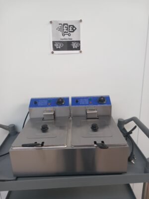 Front view of a Commercial Double Fryer with stainless steel baskets inserted and lids securely in place, ideal for high-volume frying in professional kitchens.