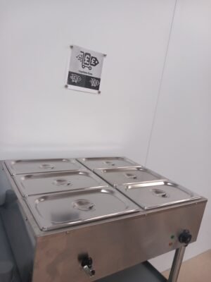 Slightly left-angled view of a commercial 6-pot bain marie with all lids securely in place, highlighting the durable stainless steel lids and high-quality construction ideal for keeping food warm in professional kitchens.