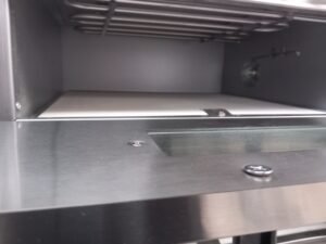 Close-up view inside the top deck of a Twin Deck Commercial Pizza Oven, highlighting the overhead heating element and stone base, designed for even heat distribution and perfect pizza crusts.