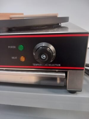 Close-up view of the durable temperature control dial on a commercial crepe maker, featuring precise heat adjustment for optimal cooking performance in professional kitchens.