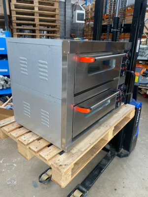 Left side view of a large commercial pizza oven with doors closed, highlighting the solid stainless steel build and compact design ideal for heavy-duty use in commercial kitchens.